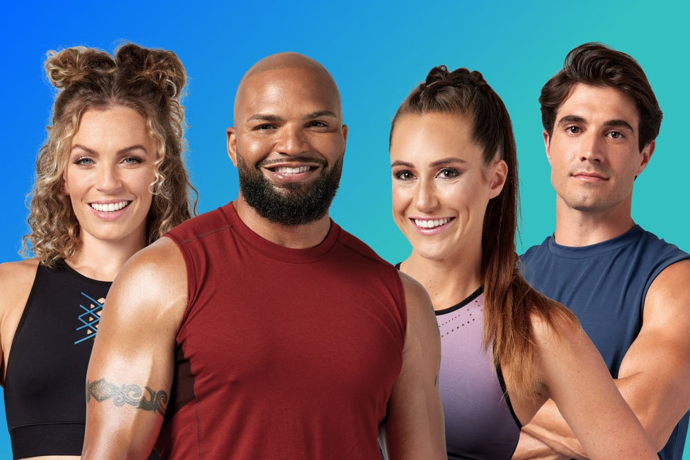 a group of four people who are coaches in workout wear smiling