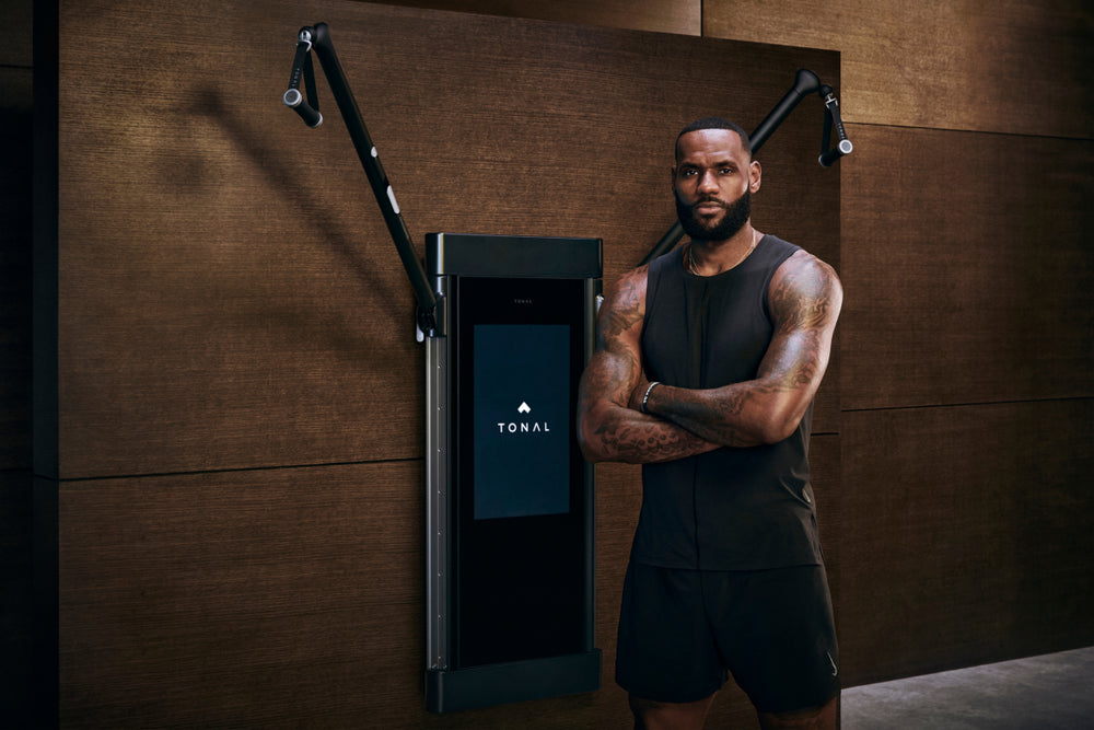 LeBron James standing in front of Tonal to demonstrate his new partnership