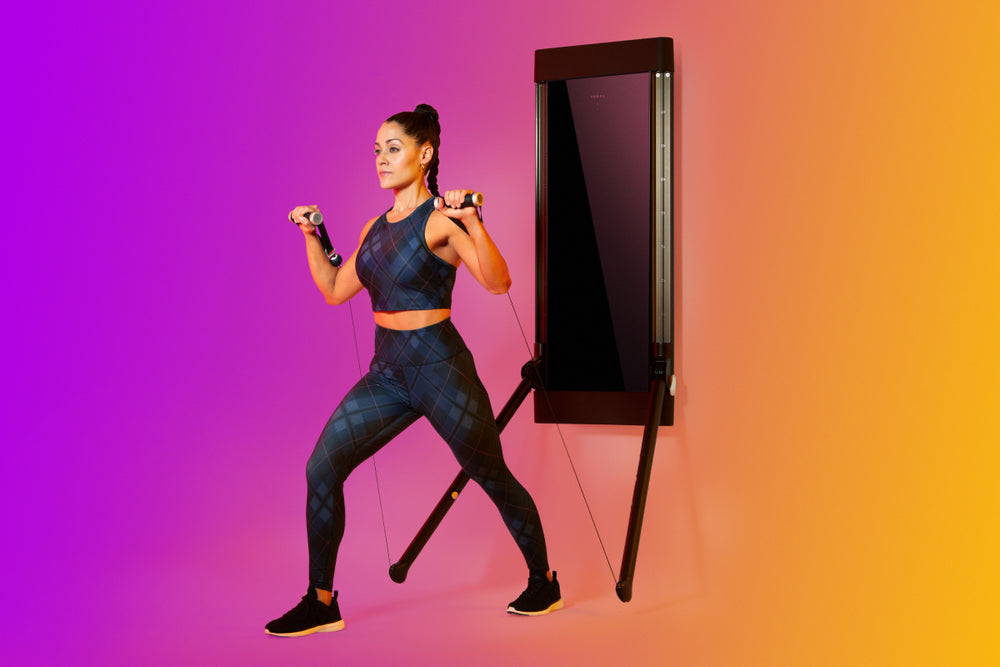 woman strength training on Tonal to illustrate the benefits of strength training.