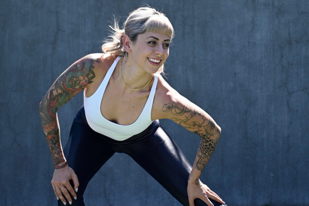 A woman smiling in workout gear