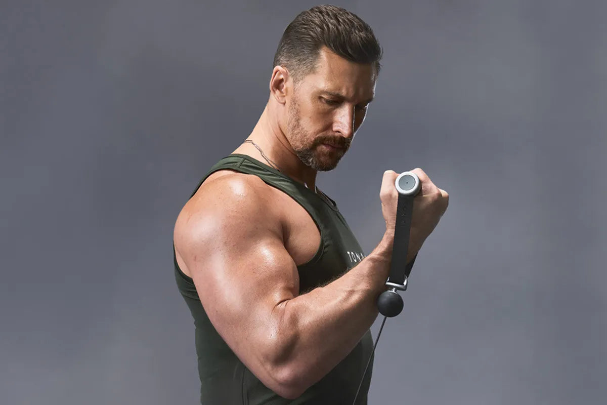 a man performing bicep curls with the Tonal