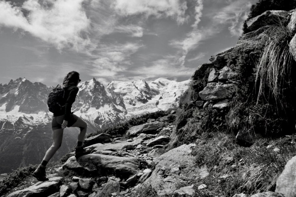 woman walking up a mountain