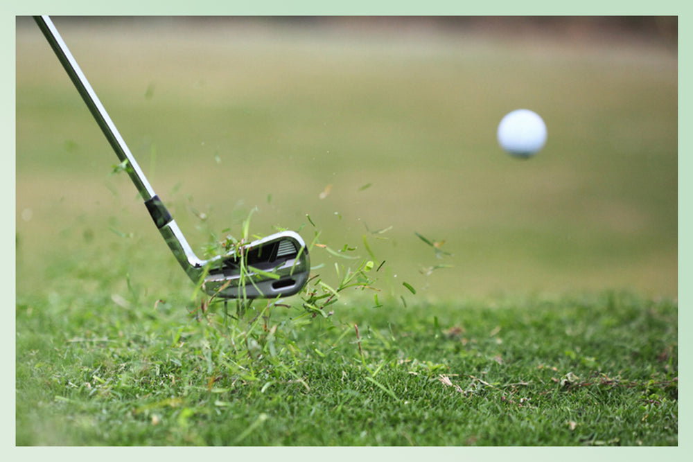 Golf club making contact with golf ball