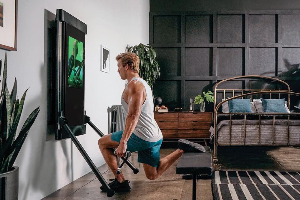 a man working out on Tonal in his apartment