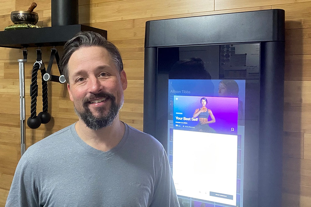 a man standing by his Tonal smiling