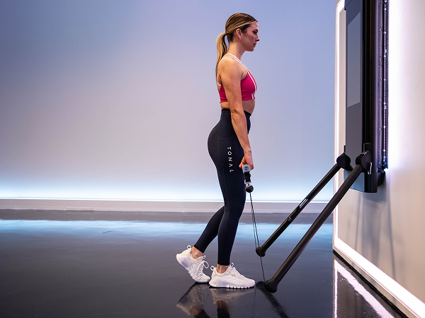 Tonal instructor doing shoulder shrug
