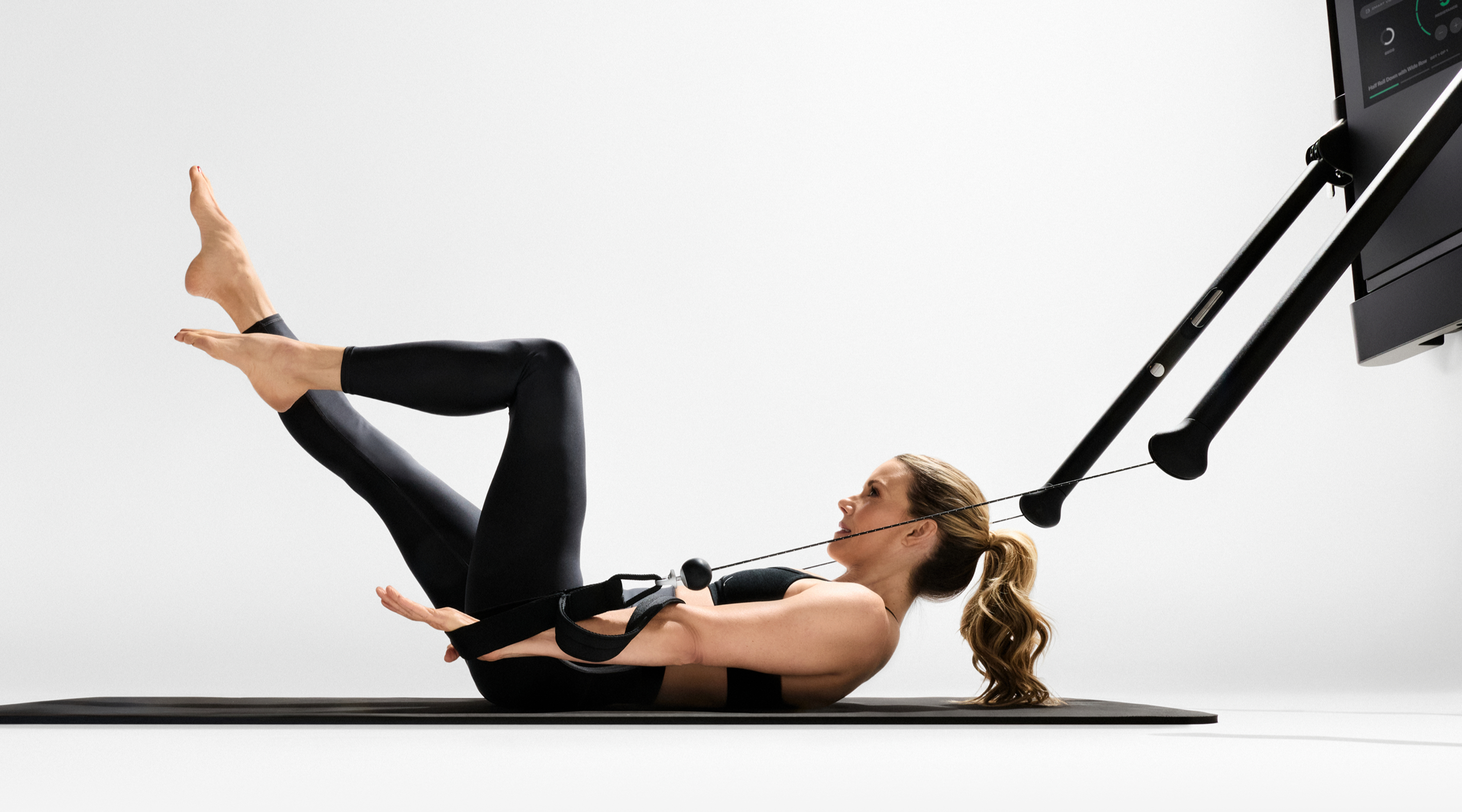 Tonal Coach Kristin McGee performed The Hundred, a foundational Pilates workout move. 