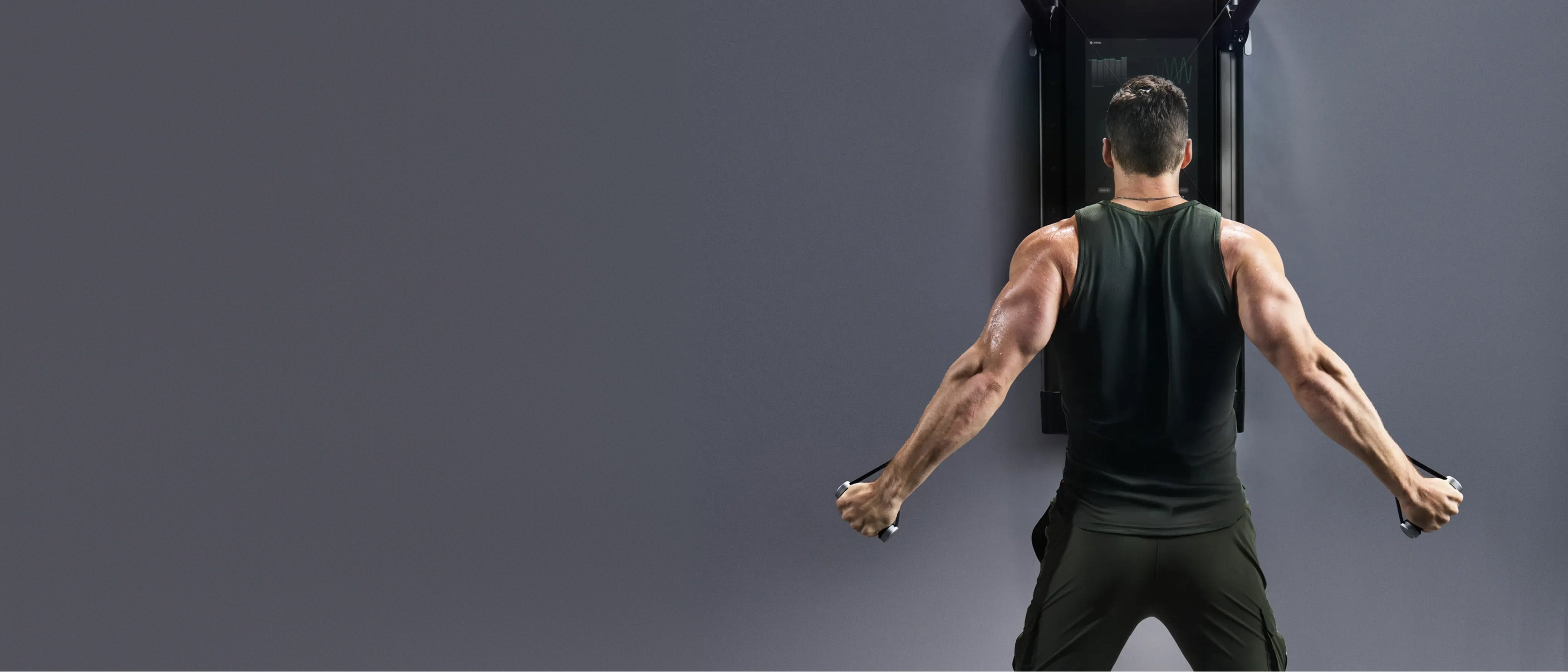 Tonal Coach Joe performing a back exercise using Tonal Smart Handles