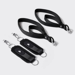 A pair of Tonal Pilates straps next to Tonal Ankle Straps