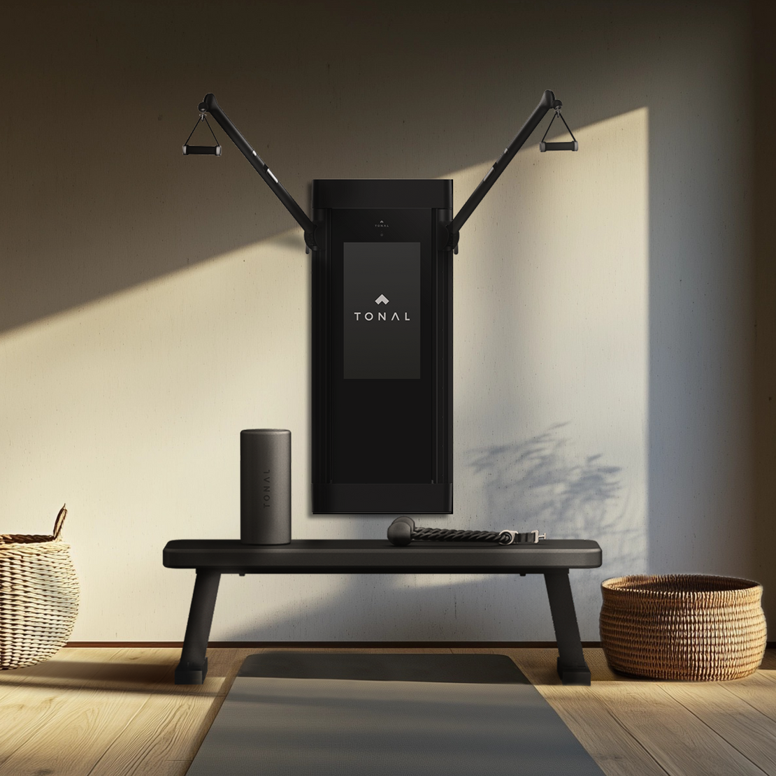 Tonal strength training system mounted on a well with accessories set out and ready for a workout