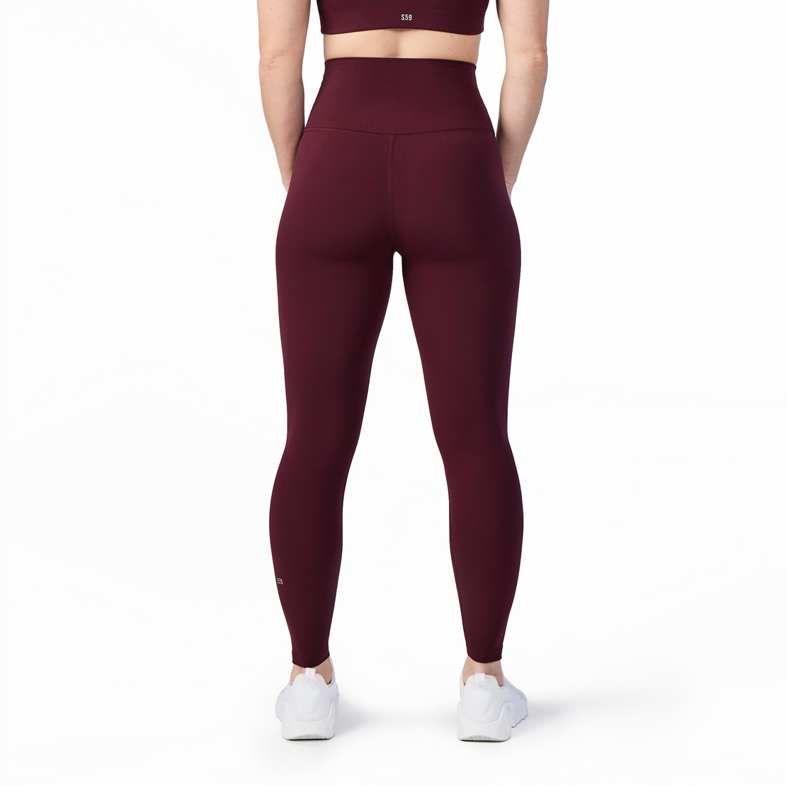 Woman wearing Tonal x Splits59 Airweight Super High Waist 7/8 Legging in Dark Cherry