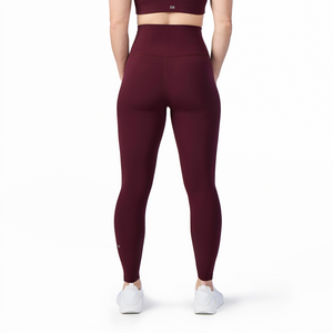 Woman wearing Tonal x Splits59 Airweight Super High Waist 7/8 Legging in Dark Cherry