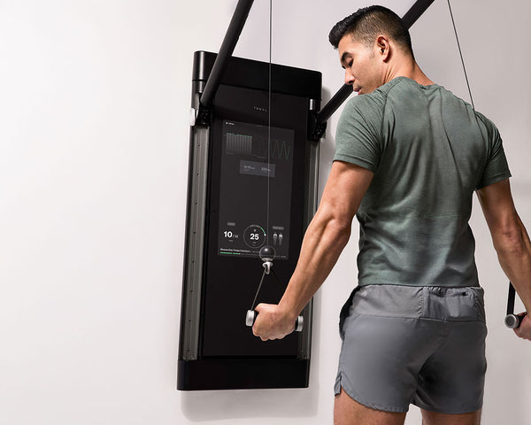 Tonal Coach Tim performs a tricep exercise