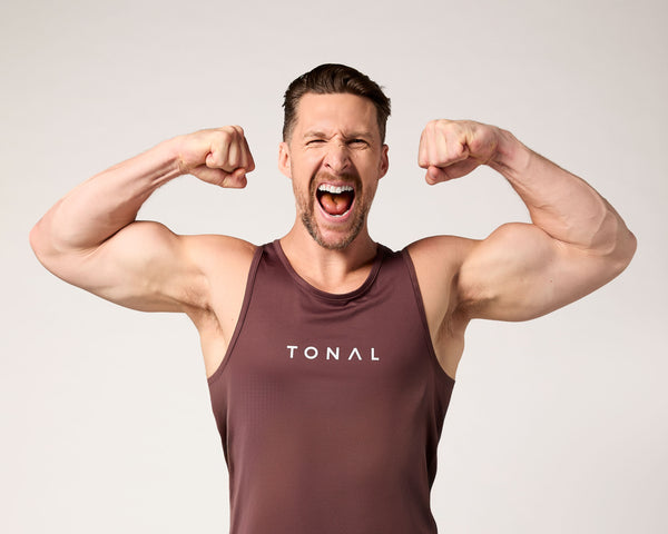 Tonal Coach Joe flexes his biceps