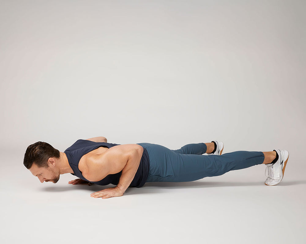 Tonal coach Joe performing a pushup during a calisthenics workout