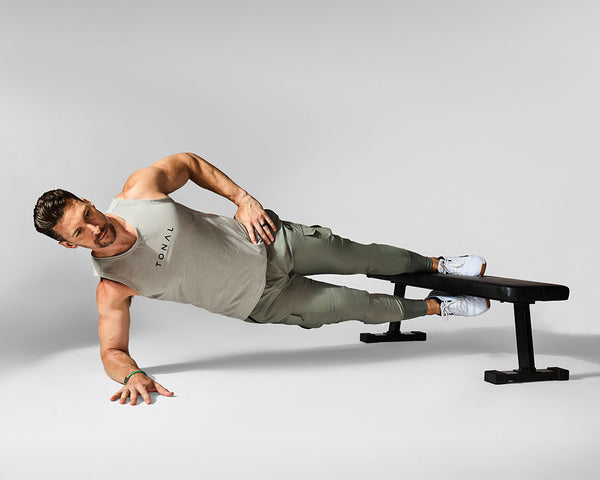 Tonal Coach Joe performing a Copenhagen Plank, exercising his Oblique muscles