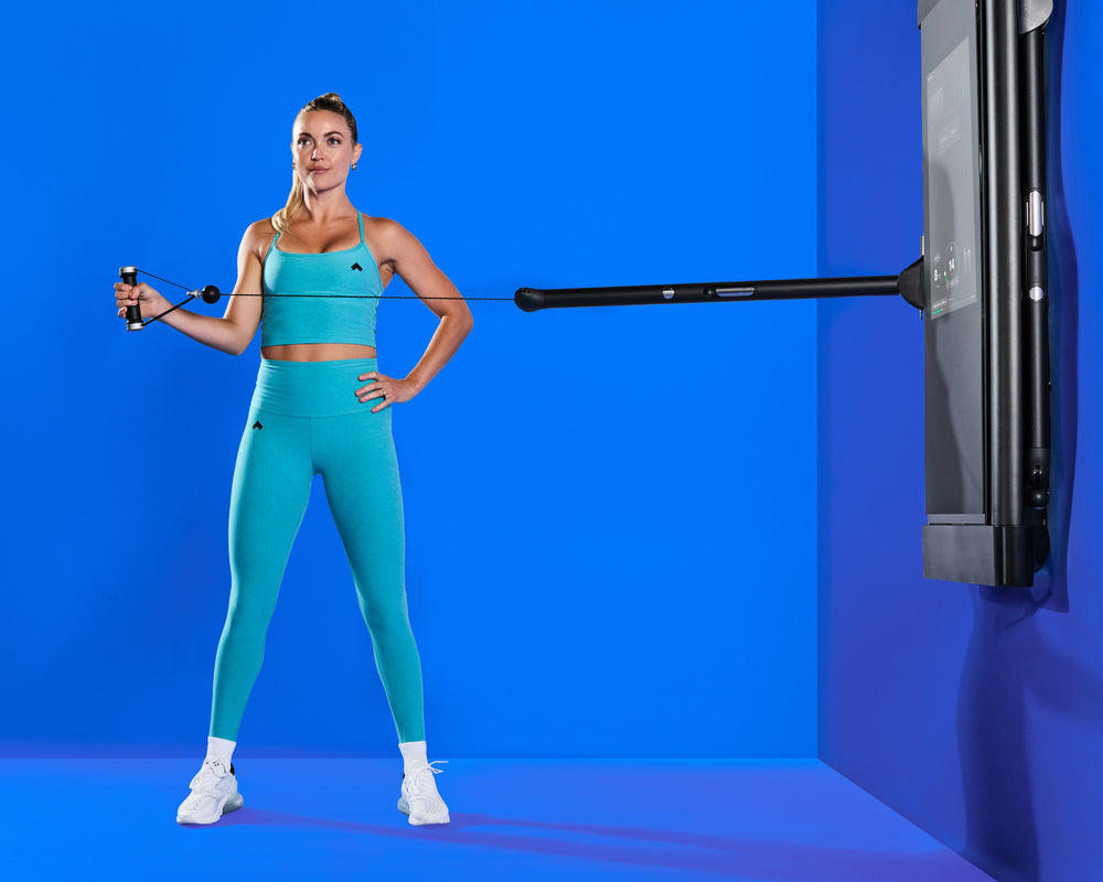 Tonal Coach Shelby performing a External Rotation exercise to tone her Shoulders.