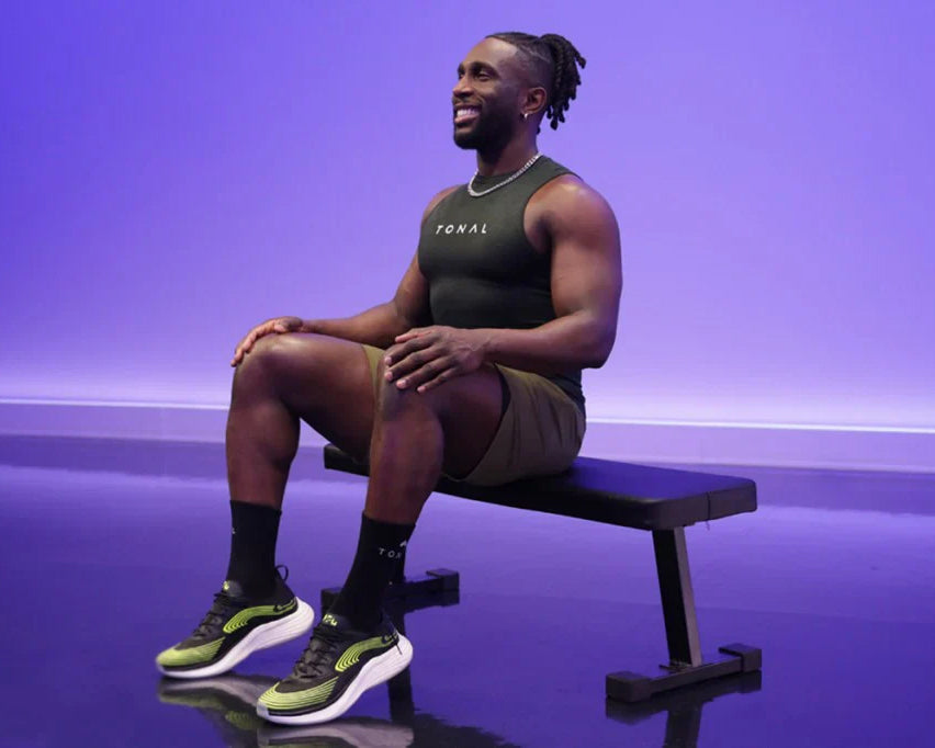Tonal Coach Ackeem performing seated calf raises