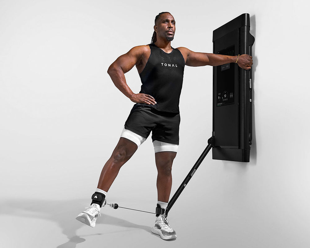 Tonal Coach Ackeem performing a Standing Hip Abduction exercising his thigh