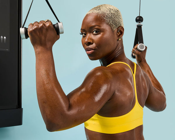 Tonal Coach Tanysha Renee perfoming a seated cable lat pulldown on Tonal.