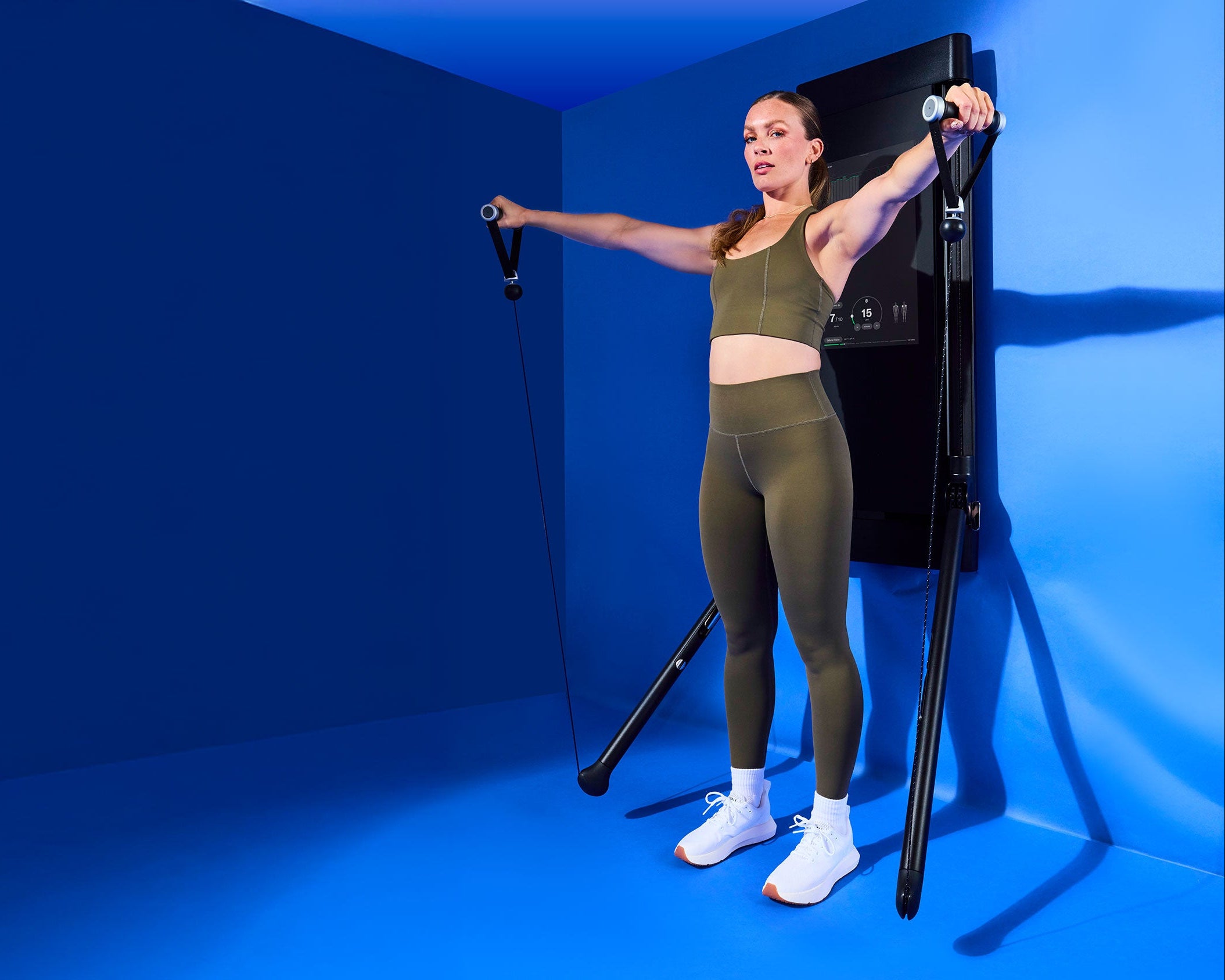 Tonal Coach Kendall Wood performing cable lateral raises on Tonal.