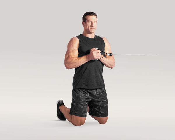 Tonal coach performing kneeling pallof press