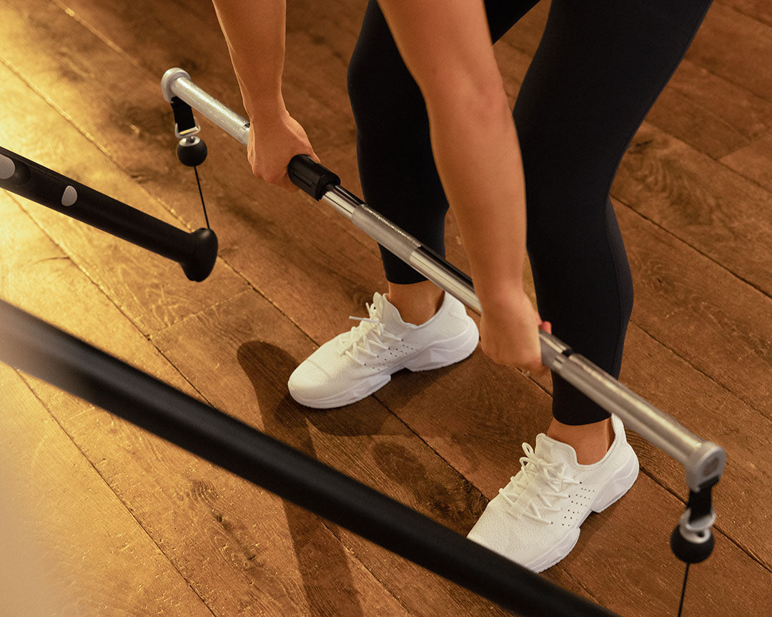 Tonal member performing a Barbell Romain Deadlift