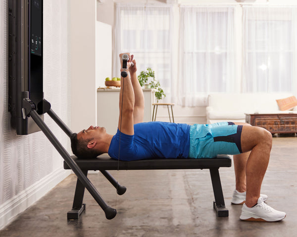Tonal Coach Tim Landicho performing a barbell bench press.