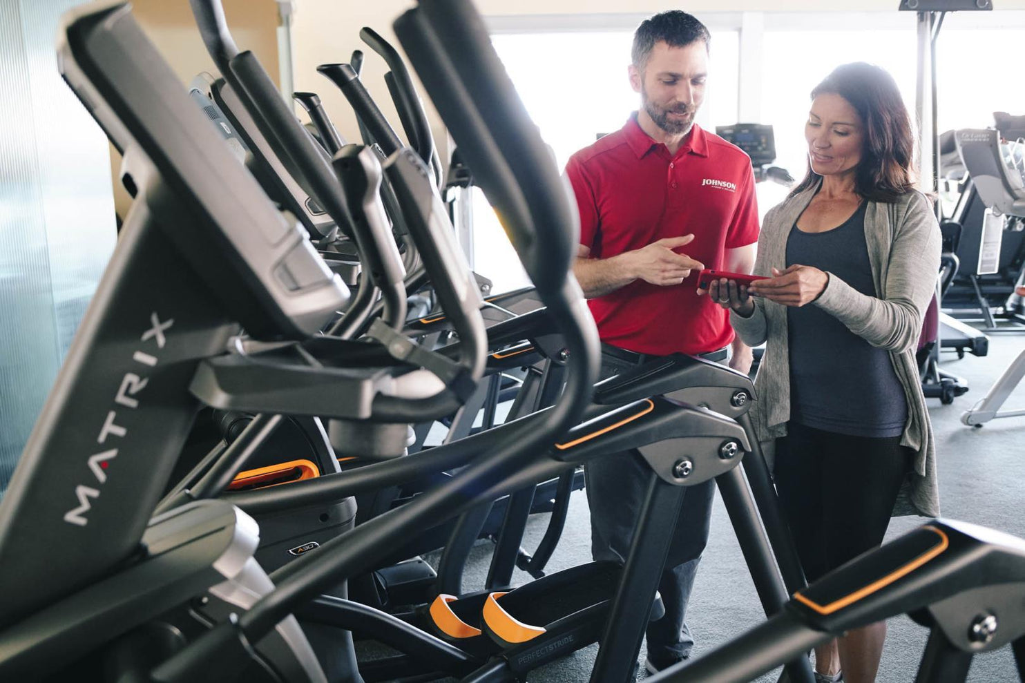 Johnson Fitness associate helping customer