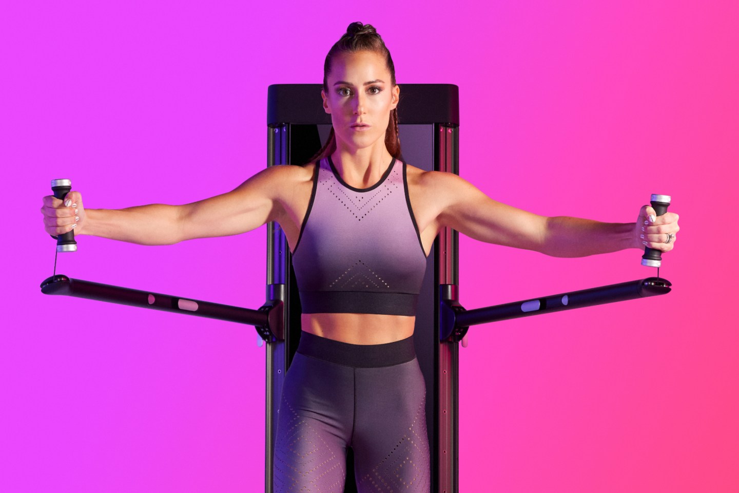 a woman doing a chest fly on tonal