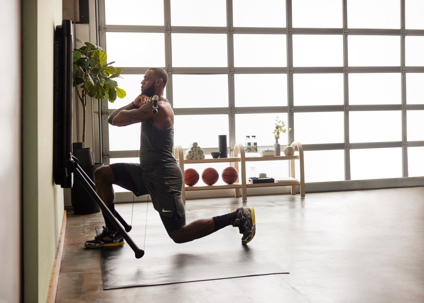 LeBron James performing front rack lunges on Tonal.