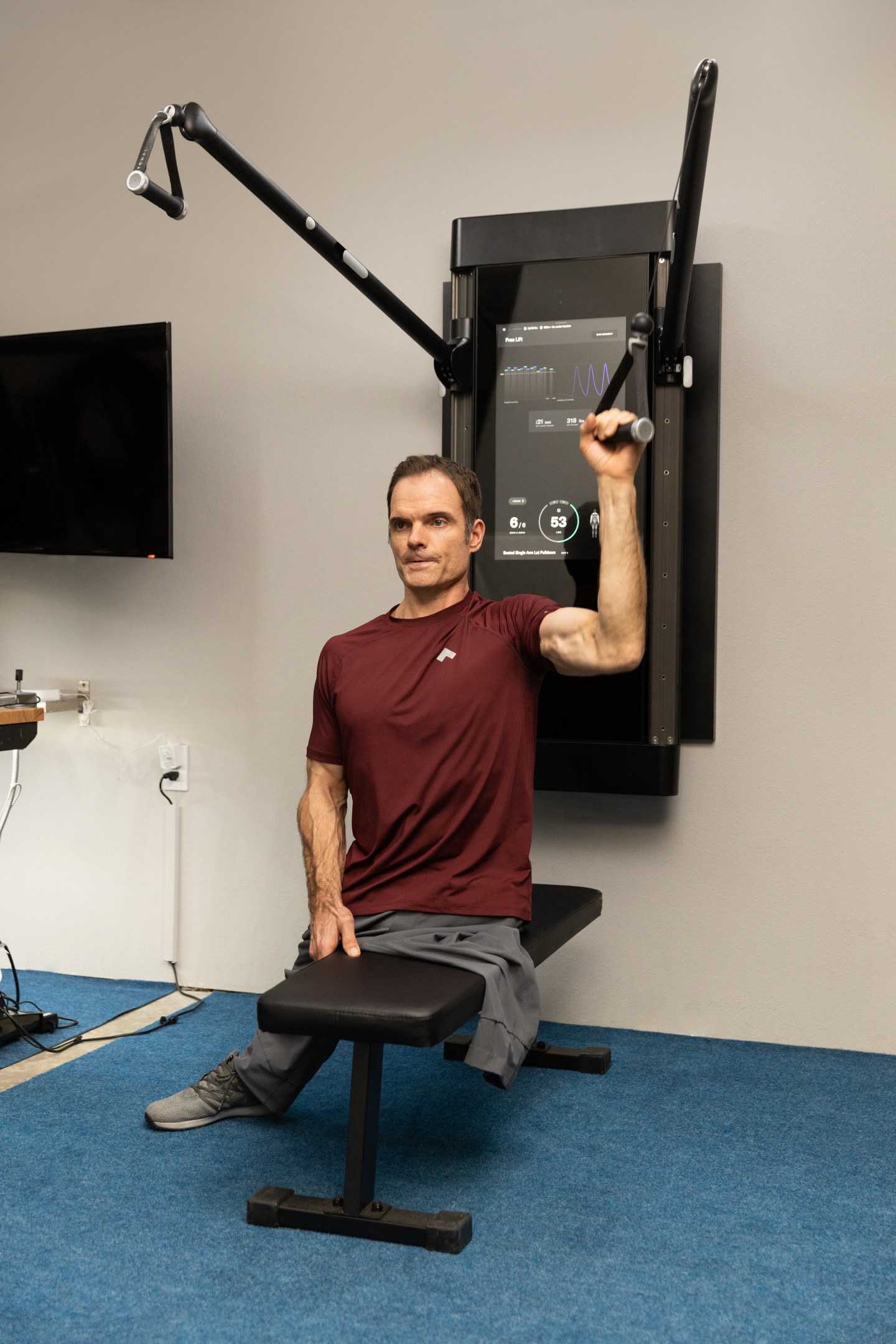 Professional handcyclist Travis Gaertner working out on Tonal.