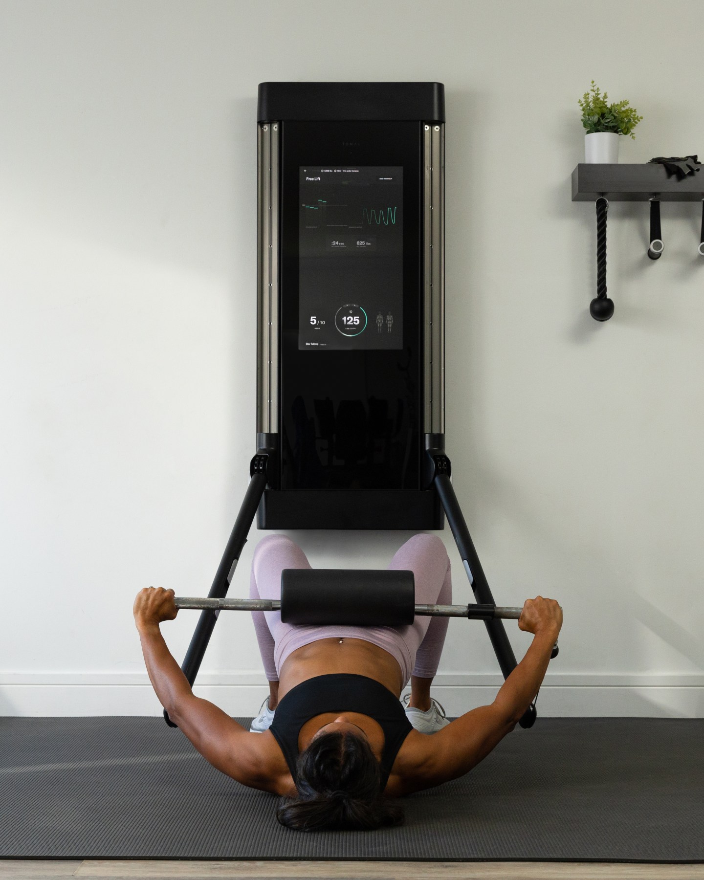 Michelle Tee doing a barbell hip thrust on Tonal. 