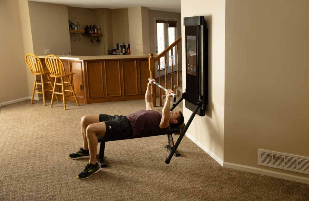 John Sill performing a bench press on Tonal