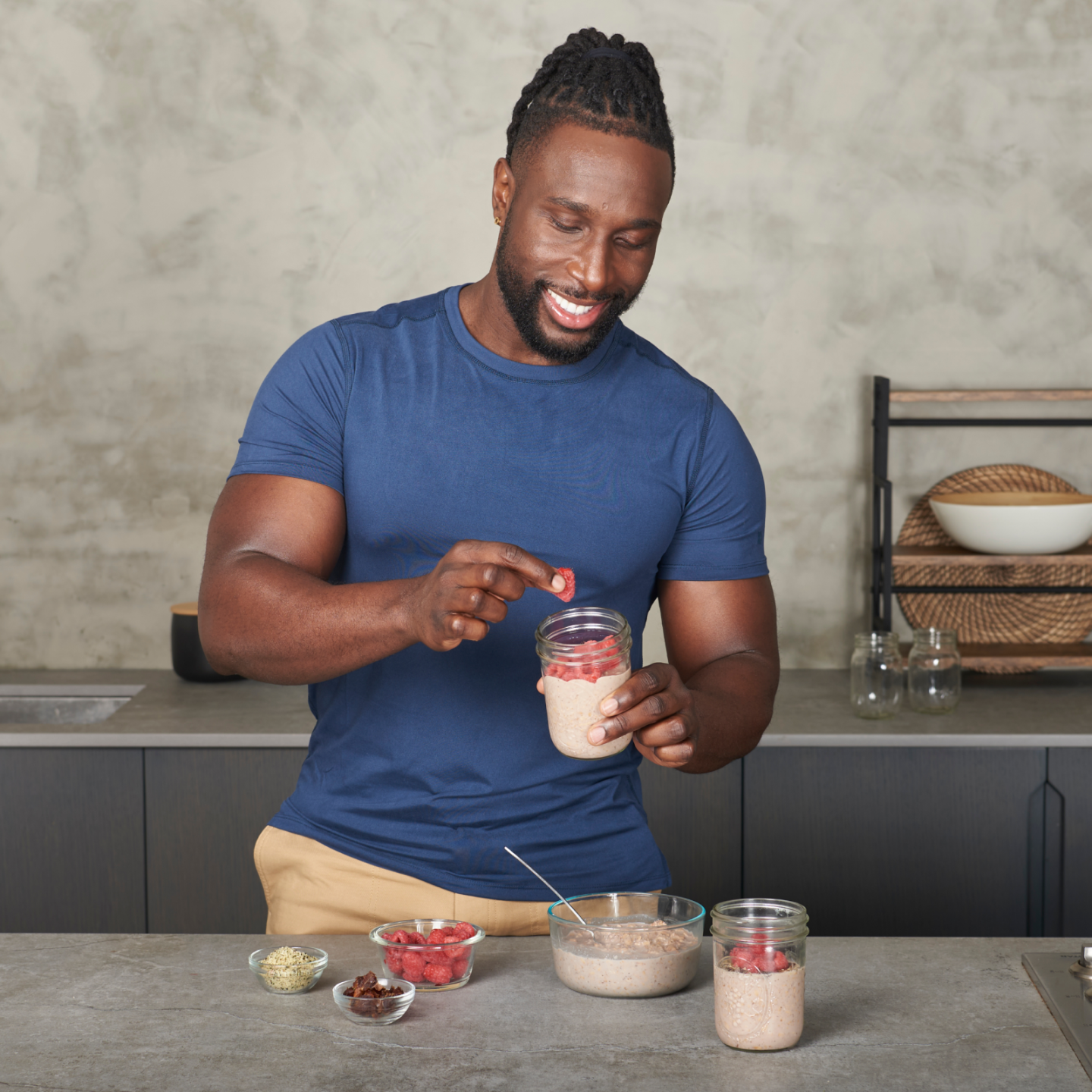 Coach Ackeem Emmons adding raspberries to his raspberry date overnight oats.