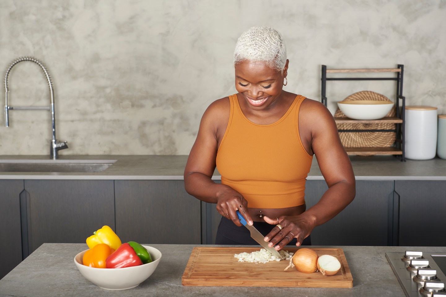 Coach Tanysha Renee cutting up onions and meal-prepping.